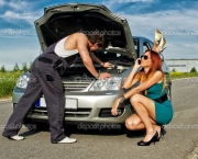 Mechanic fixing a car on a road