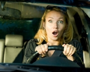 Fright face of  woman driving car and strongly squeeze the wheel
